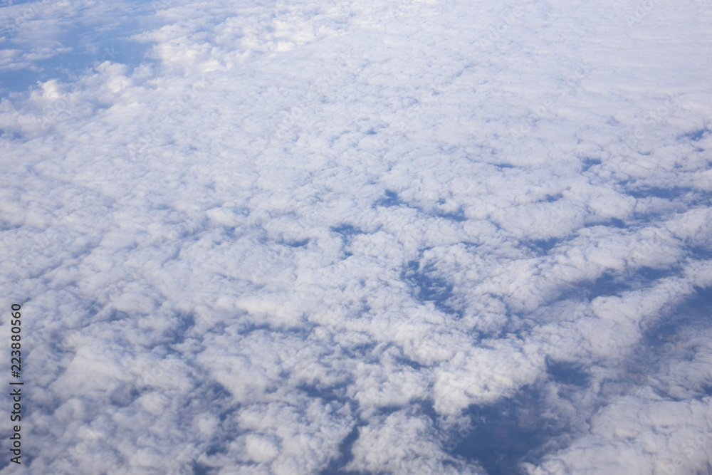 Could in the sky under tha airplane from the window of plane