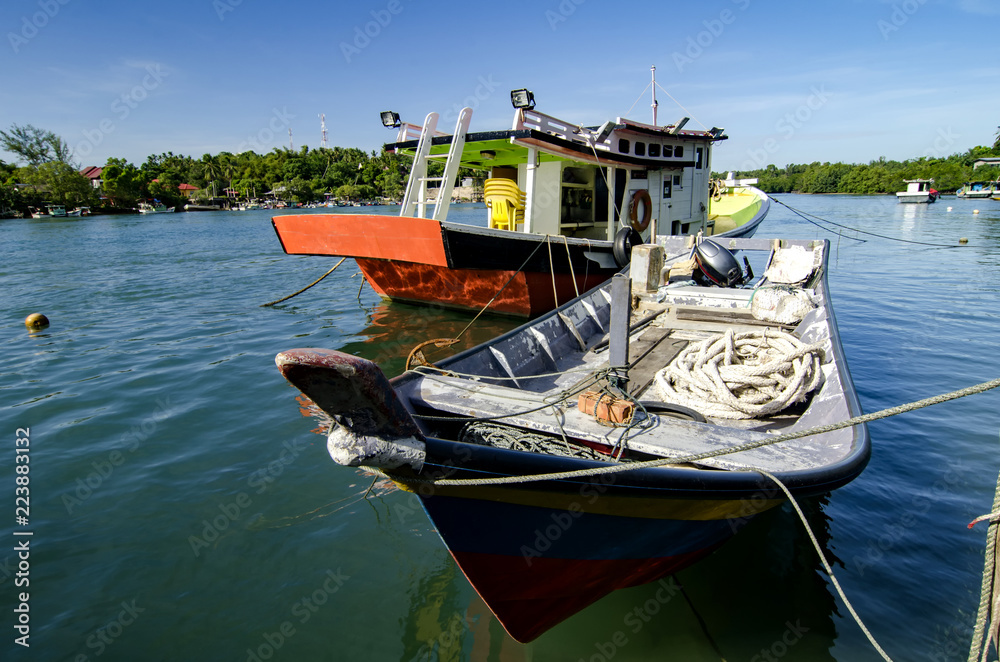 beautiful village in Terengganu, Malaysia with background of traditional fisherman boat moored at sunny day beautiful village in Terengganu, Malaysia with background of traditional fisherman boat moored at sunny day