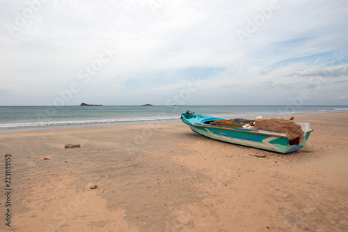 Small boat on Nilaveli beach in Sri Lanka Asia © htrnr