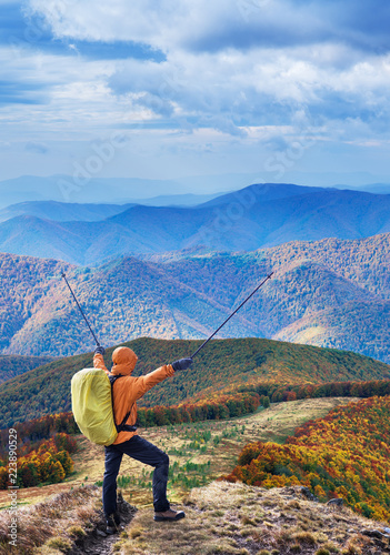Hiker enjoying the trip in the top of mountain.