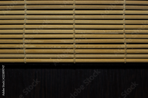 pattern of sushi wooden cover mat background texture and board with dark black space, copy space for text