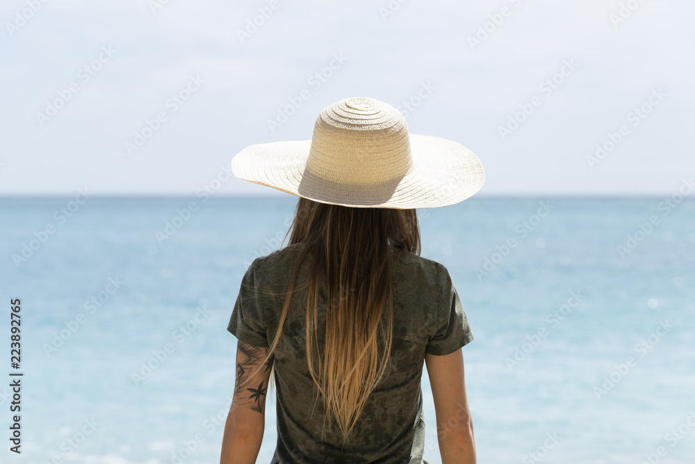 Girl with hat in beach