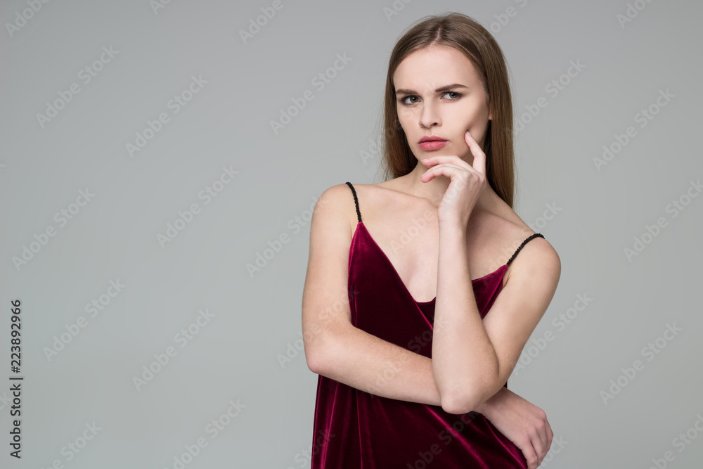 Blond girl in red poses showing emotions: wistfulness, dreaminess, muse Blond girl in red poses showing emotions: wistfulness, dreaminess, muse