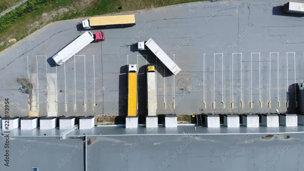 Aerial view of trucks unloading in logostics center