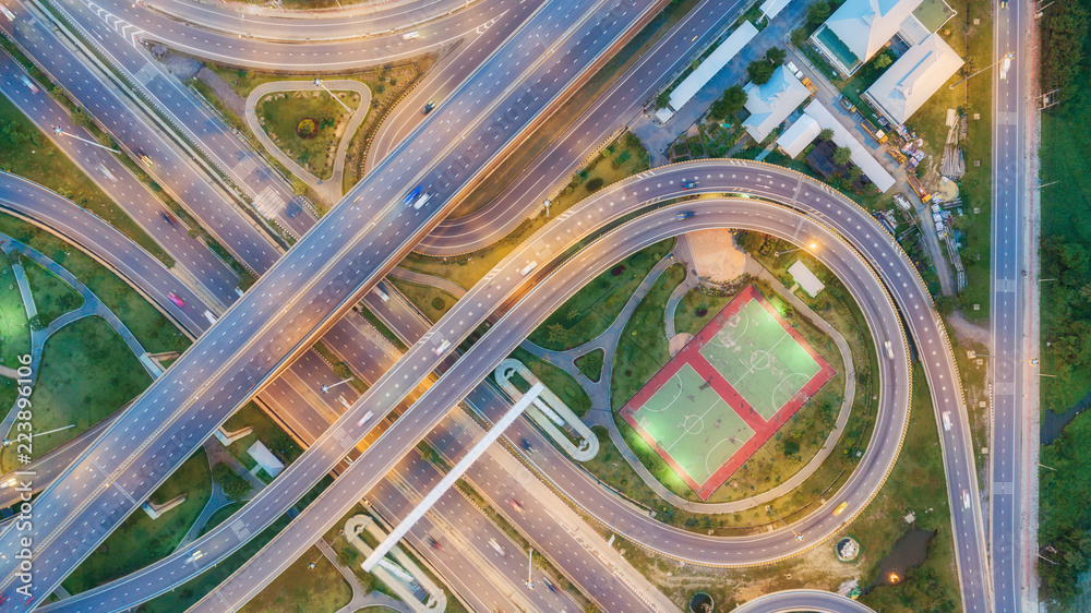 Aerial view highway road circle or intersection at dusk for transportation, distribution or traffic background. Aerial view highway road circle or intersection at dusk for transportation, distribution or traffic background.
