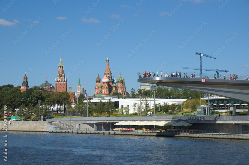 Moscow, Russia - August 24, 2018: Soaring bridge on the background of the Kremlin and St. Basil's Cathedral in Zaryadye natural landscape Park 
