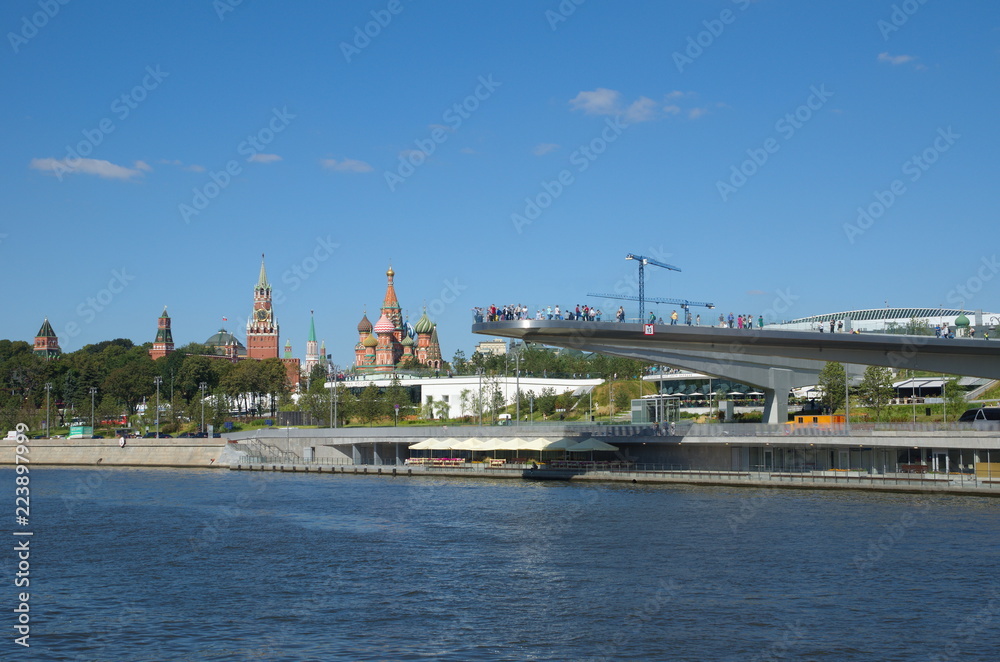Moscow, Russia - August 24, 2018: Summer view of the Soaring bridge in Zaryadye natural landscape Park, Moscow Kremlin and St. Basil's Cathedral