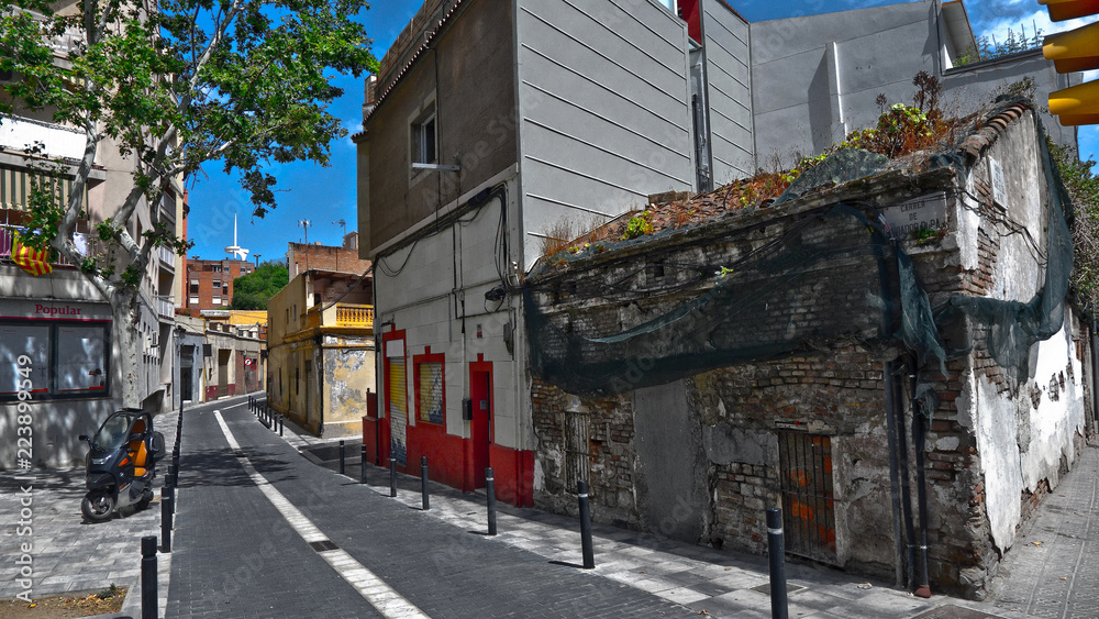 Historic streets of Barcelona with old houses and architecture of the middle ages and modern buildings – beautiful views of the Calle Mare de DEU del Port