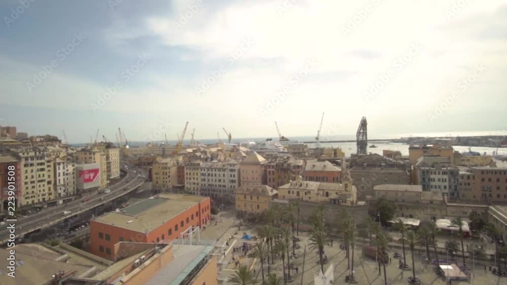 Aerial view of Geona (Genova) from bigo, the rotating panoramic tower over the celebrated acquarium. You can see cars traveling, the harbourd and the city. Aerial view of Geona (Genova) from bigo, the rotating panoramic tower over the celebrated acquarium. You can see cars traveling, the harbourd and the city.