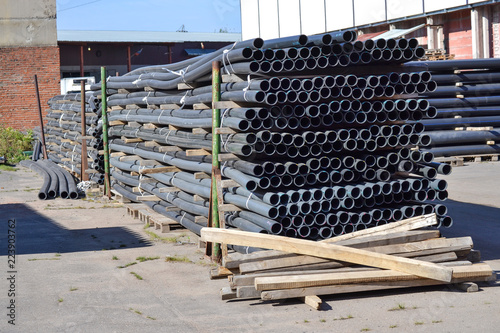 Plastic pipes in stock of finished products stacked in packs photo