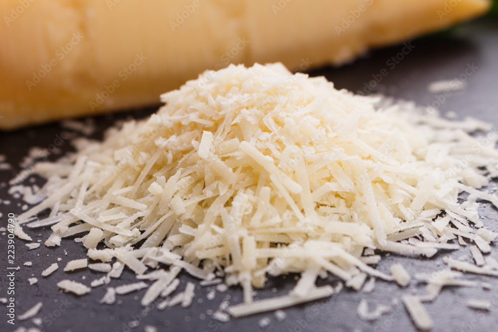 fragrant grated Parmesan on a slate stone slicing board fragrant grated Parmesan on a slate stone slicing board