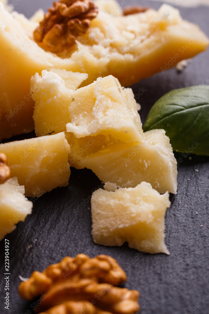 fragrant Parmesan on a slate stone slicing board fragrant Parmesan on a slate stone slicing board