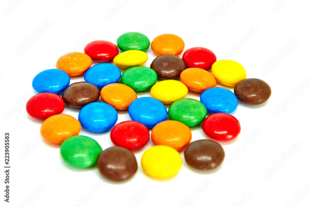 colorful chocolate buttons on a white background colorful chocolate buttons on a white background