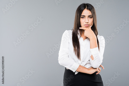 Young beautiful business woman thinking or making choice, isolated on white background