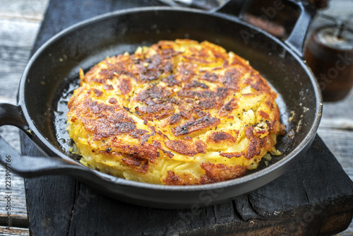 Traditional Swiss rösti as side dish as closeup in a frying pan