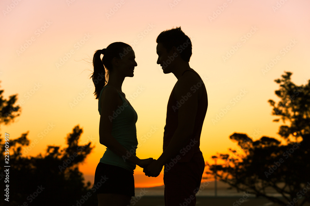 Man and woman holding hands looking into each others eyes. People love relationship concept.