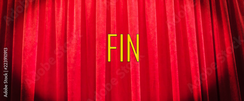 Red a curtain with a graphic inscription in French, with the translation of 