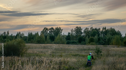 Bicyclists in the field in Russia