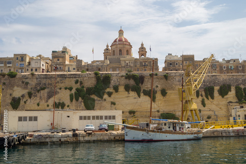 A sailing boat moored at the fortified City of Senglea, Malta.