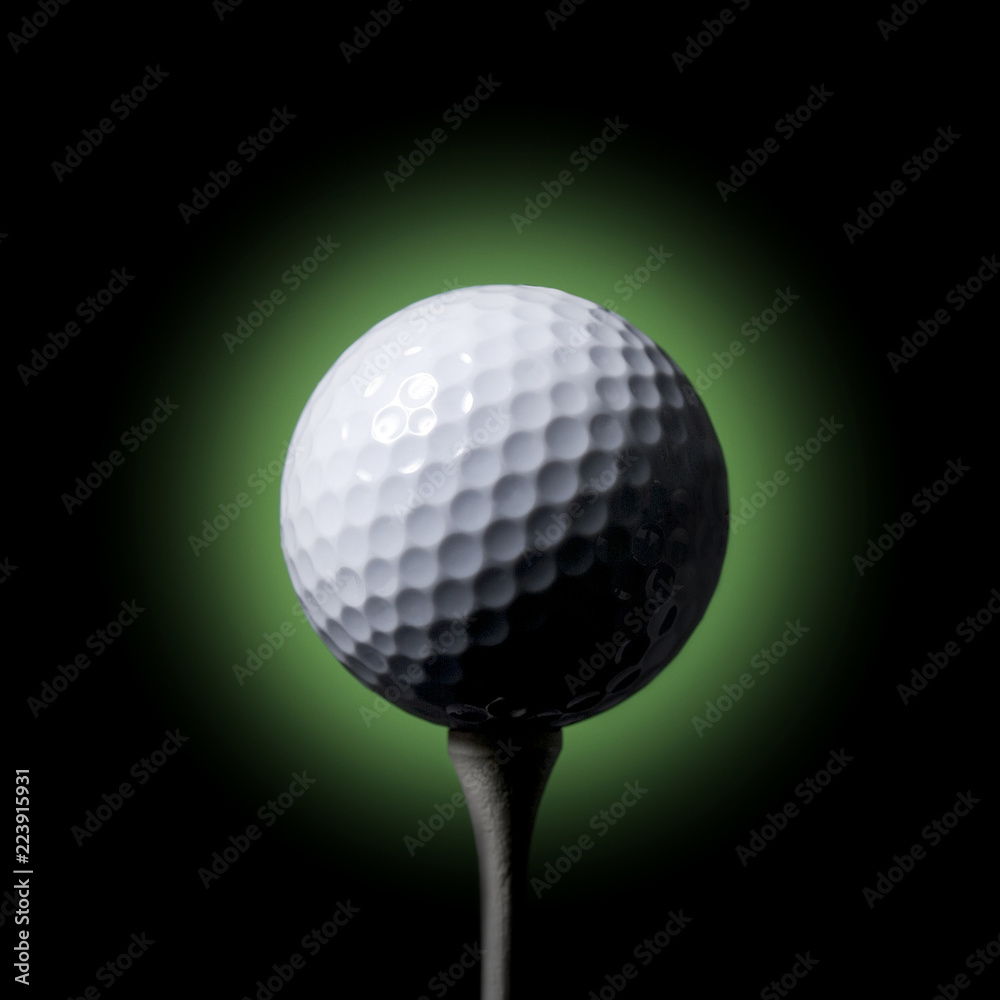 Golf ball on Tee black background Golf ball on Tee black background