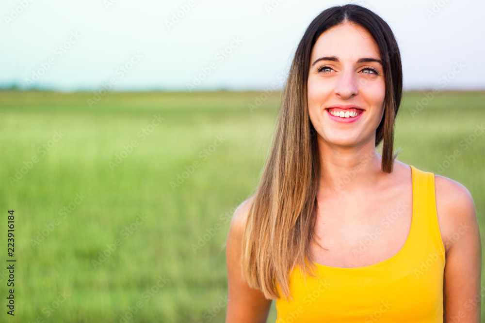 Portrait of beautiful woman in meadow
