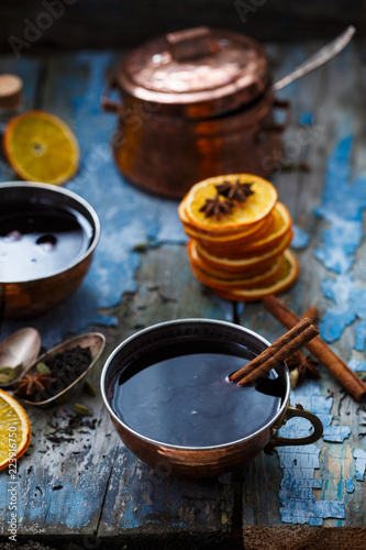 Grog in copper cups with spices and orange slices
