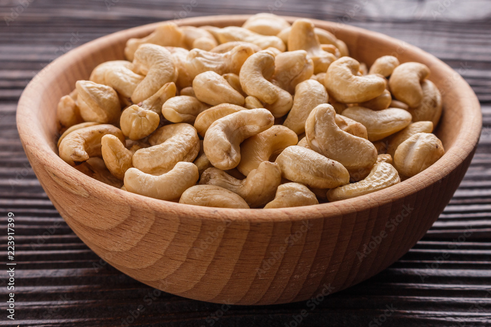 cashew nuts on a rustic wooden background cashew nuts on a rustic wooden background