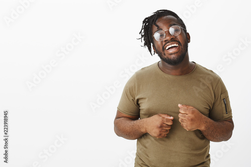 Bild auf Leinwand Indor shot of cheerful handsome plump man in glasses, smiling broadly with opene