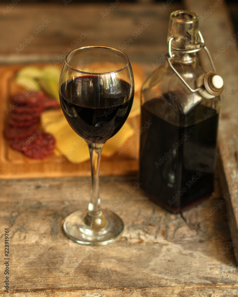 glass of red wine and a bottle on the table (alcohol). Top view. food background copy space glass of red wine and a bottle on the table (alcohol). Top view. food background copy space