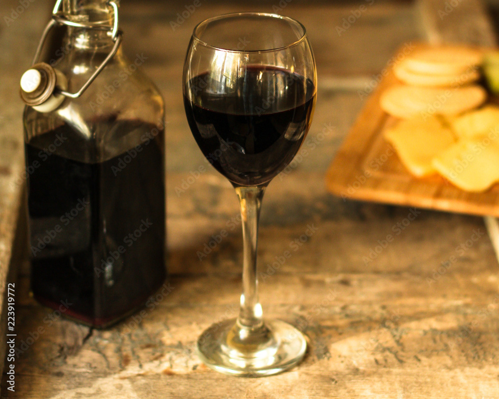 glass of red wine and a bottle on the table (alcohol). Top view. food background copy space