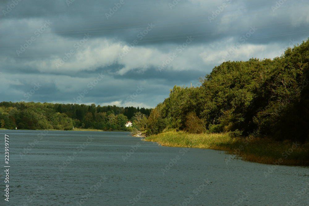 landscape on the river bank with clouds in inclement weather landscape on the river bank with clouds in inclement weather