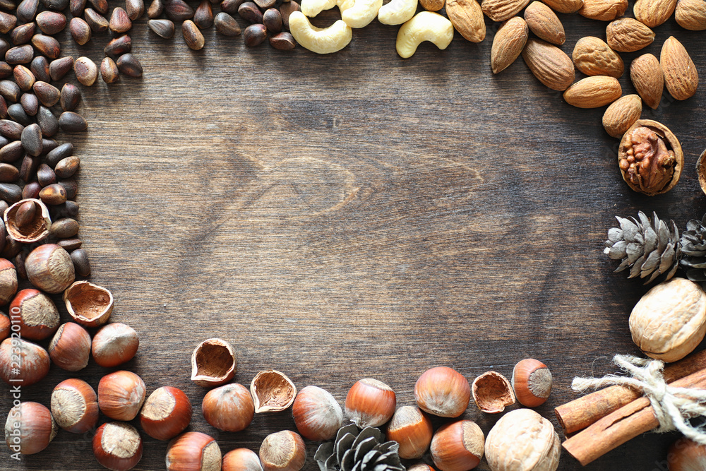 Different nuts on a wooden table. Cedar, cashew, hazelnut, walnu Different nuts on a wooden table. Cedar, cashew, hazelnut, walnu