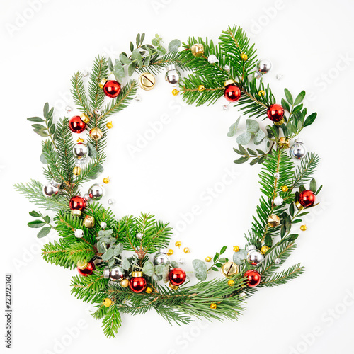 Beautiful round frame of fir and pine branches with Christmas decorations white background. Christmas concept. Flat lay, top view