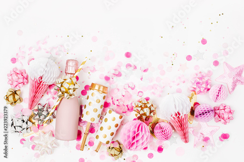 Pale Pink Mini bottles of champagne with confetti, tinsel and paper decoration. Flat lay, top view. New year/Christmas celebration or wedding  concept theme. Flat lay, top view