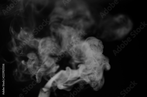 White smoke on a black background. Texture of smoke. Clubs of wh