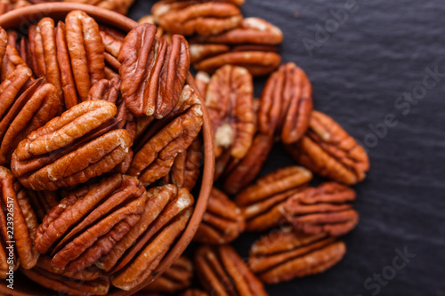 delicious pecan nuts on a dark stone background