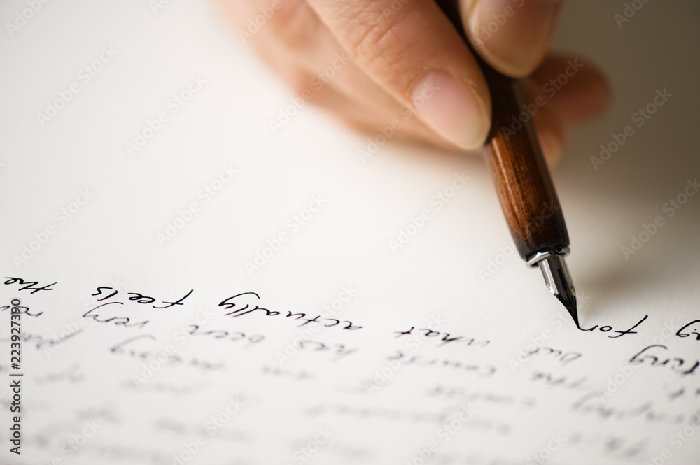Fototapeta premium Writing letter to a friend. Selective focus and shallow depth of field.