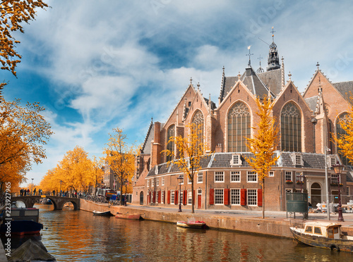 Oude Kerk over canal at spring day, Amsterdam at fall, Holland photo
