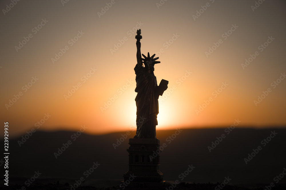 Statue of Liberty on the background of colorful dawn sky Statue of Liberty on the background of colorful dawn sky