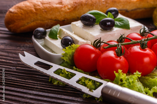 A piece of feta cheese on a wooden rustic background