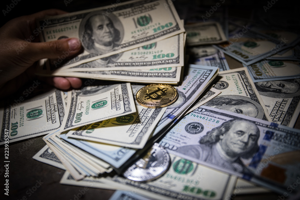 golden bitcoin coin on us dollars close up golden bitcoin coin on us dollars close up