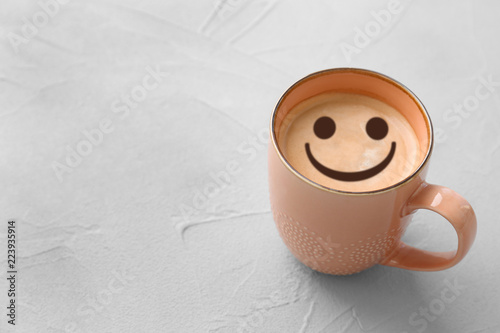 Cup of aromatic hot coffee on light background