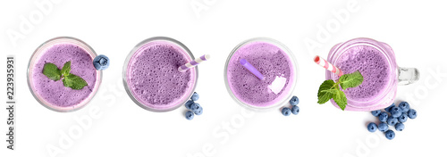 Set with delicious blueberry smoothie on white background, top view