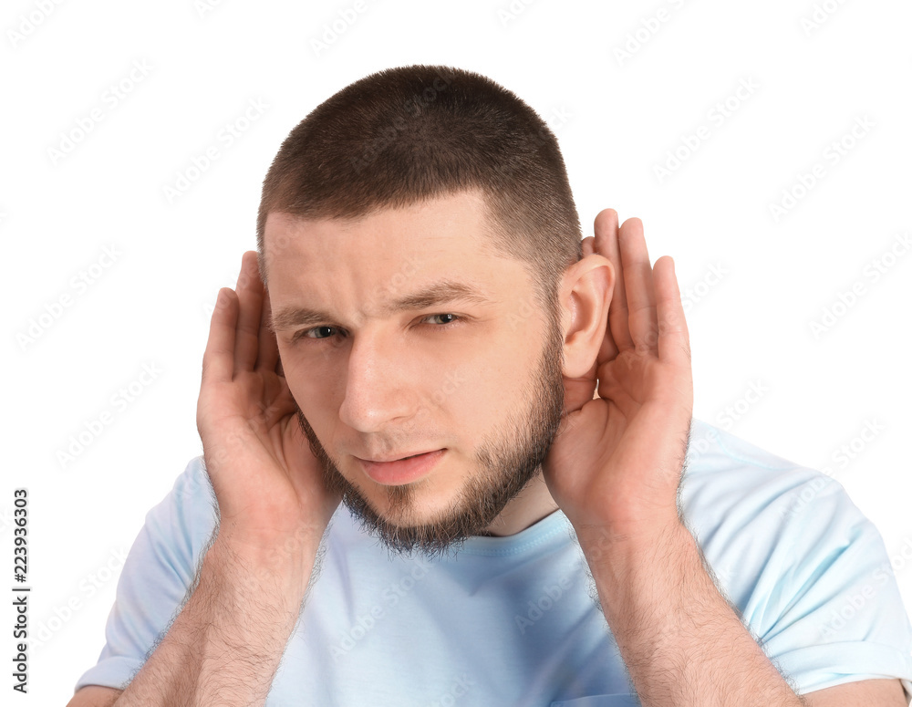 Young man with hearing problem on white background Young man with hearing problem on white background