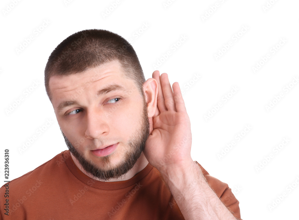 Fototapeta premium Young man with hearing problem on white background