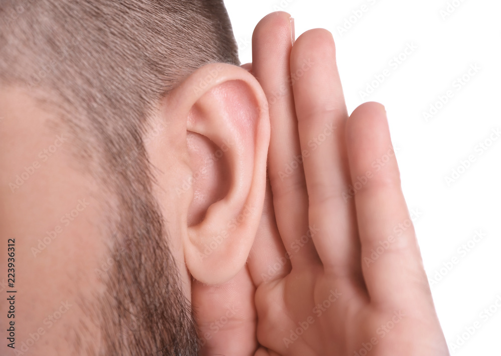Fototapeta premium Young man with hearing problem on white background, closeup