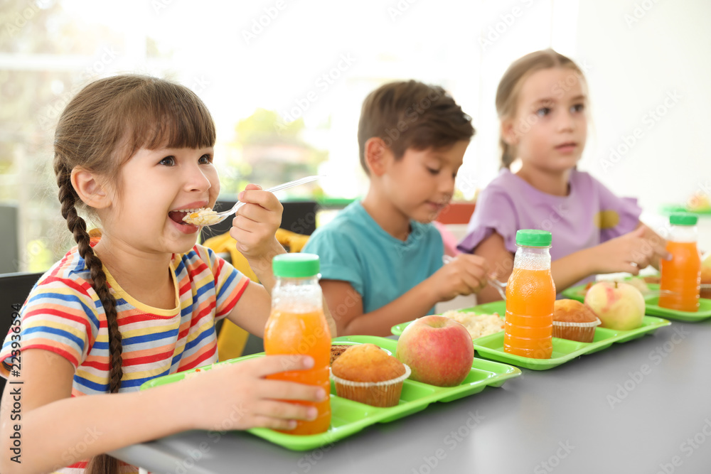 Children sitting at table and eating healthy food during break at school Children sitting at table and eating healthy food during break at school