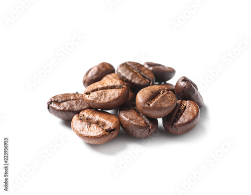 Pile of roasted coffee beans on white background