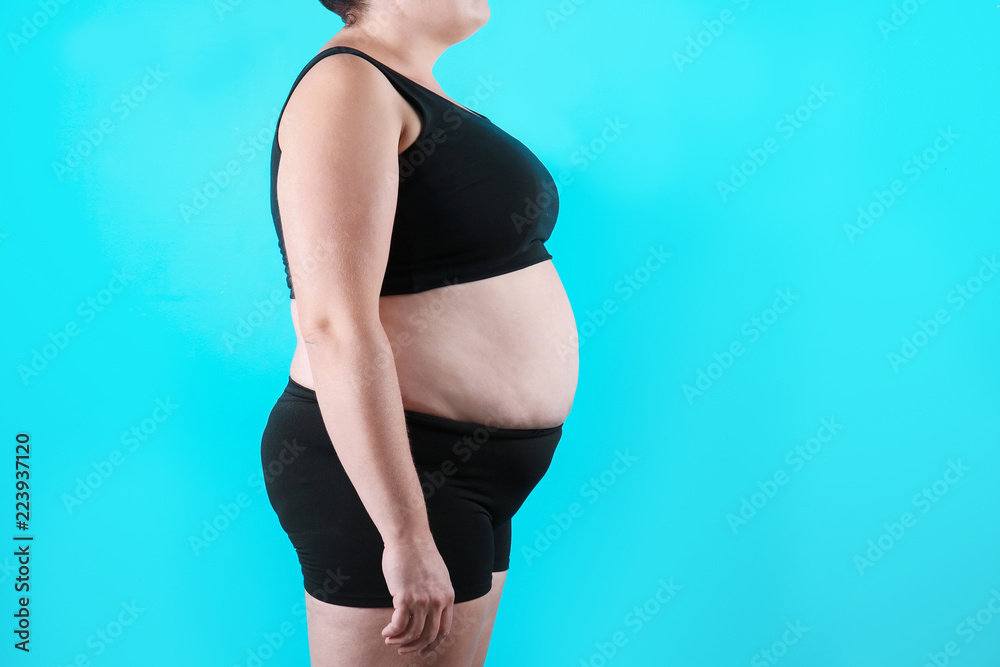 Fototapeta premium Fat woman on color background, space for text. Weight loss