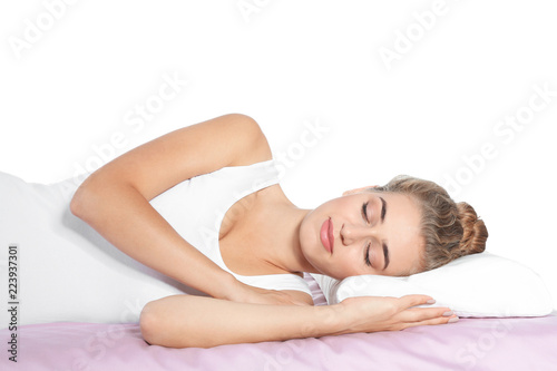 Beautiful woman sleeping with orthopedic pillow on bed against white background